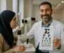 Muslim optometrist providing eye care for a hijabi patient in the UK.